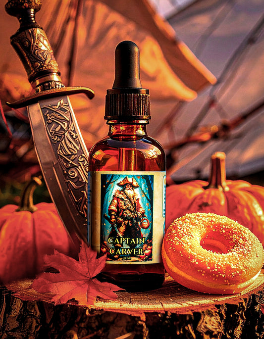 Bottle of Captain Carver beard oil with a knife, donut, and pumpkins on a wooden surface.